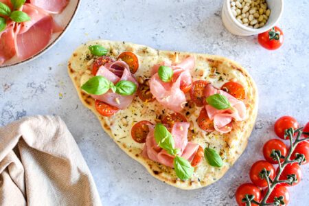 Makkelijke naanpizza uit de oven met tomaat en crème fraîche